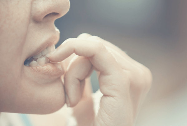 woman biting her nails, anxiety, nervous, stress