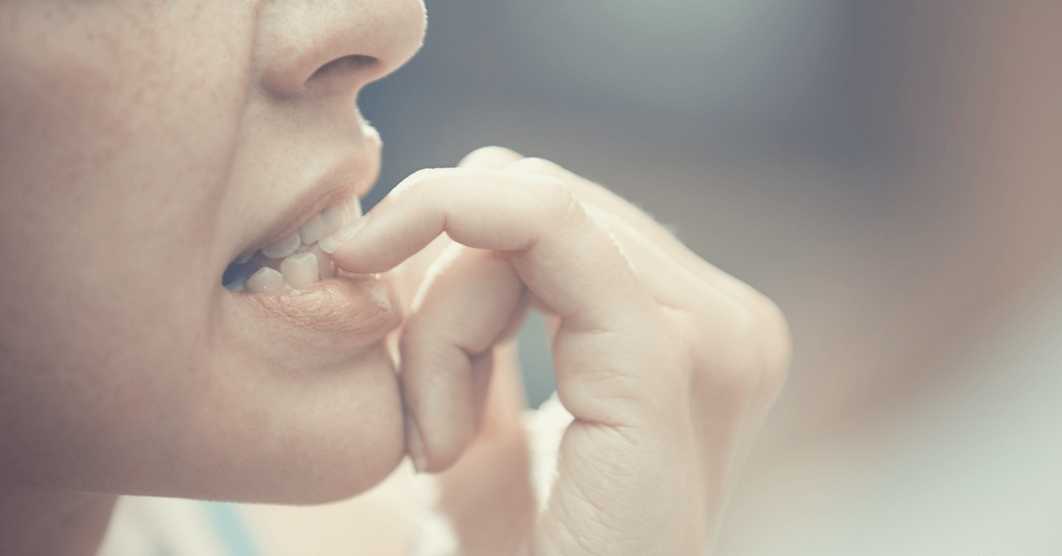 woman biting her nails, anxiety, nervous, stress