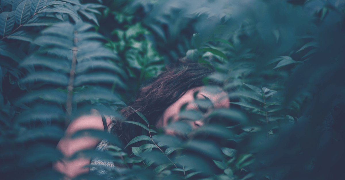 Lucid Dreaming woman sleeping in jungle leaves